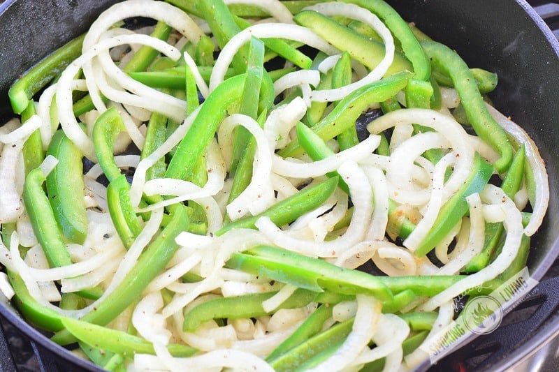 onions and peppers in the skillet