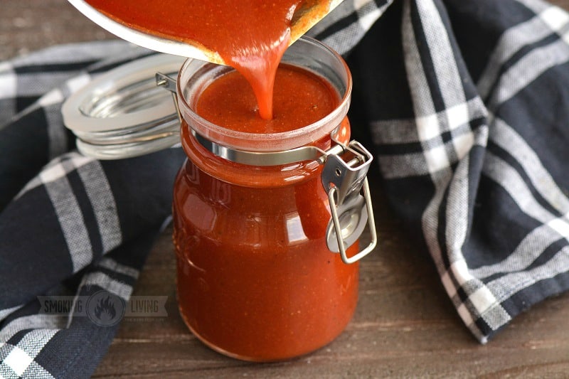 pouring cooked sauce into the jar