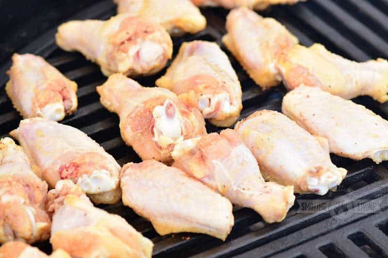 raw chicken wings on the grill