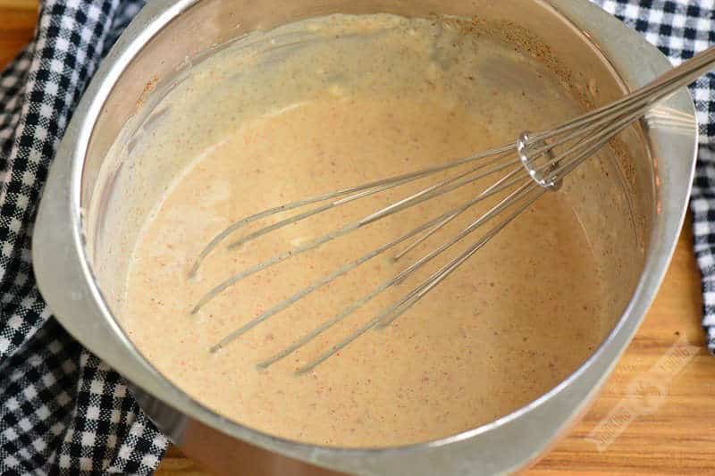 sauce in the mixing bowl with a whisk