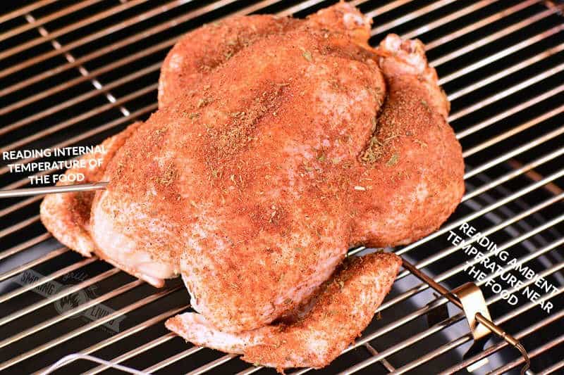 raw chicken coated with dry rub on the grill grate
