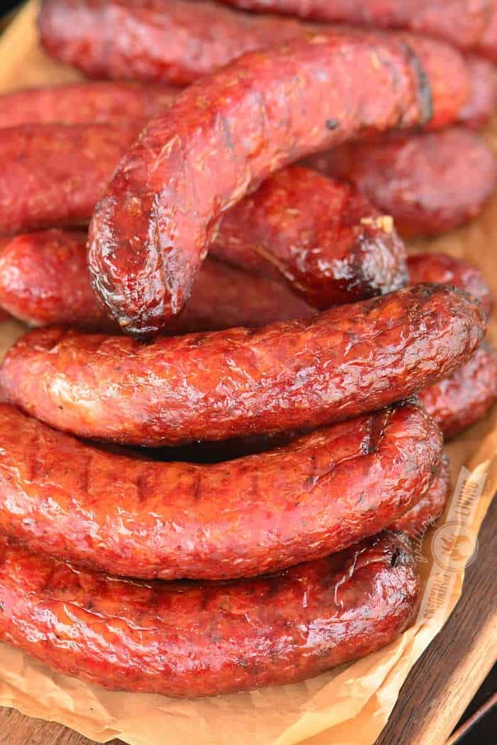 smoked sausages stacked on parchment paper