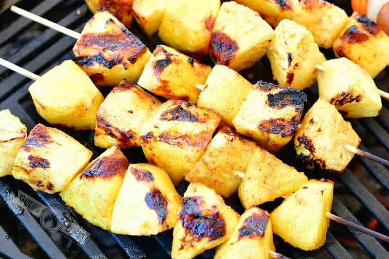 pineapple chunks on skewers on the grill