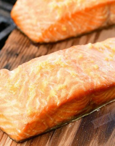 cooked salmon on a wood plank on a grill