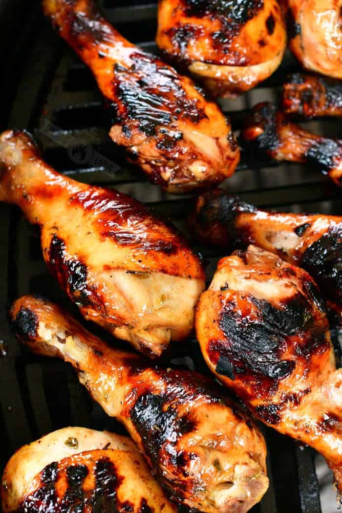 grilled chicken legs on the black grill grate