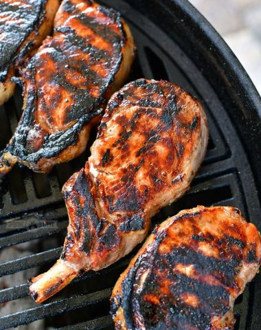 four grilled pork chops on the grill