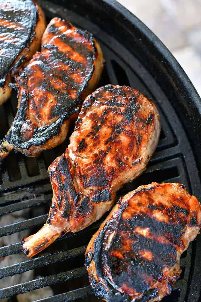 four grilled pork chops on the grill
