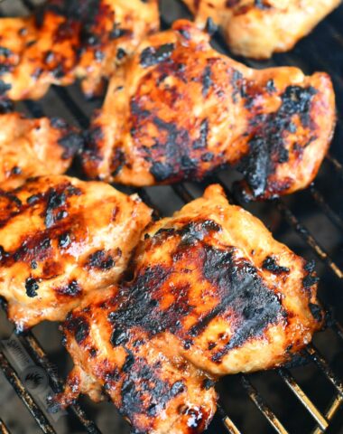 chicken thighs cooking on the grill