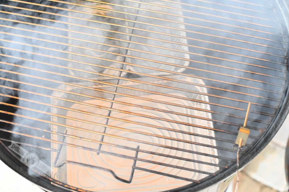 three aluminum pans on the lower smoker grate