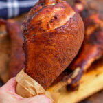 holding a smoked turkey leg