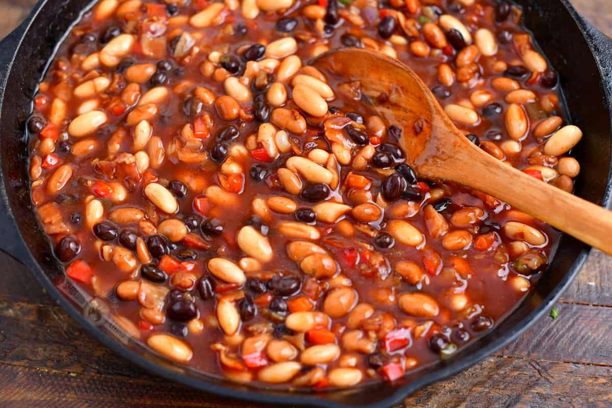 beans and vegetables mixed with bbq sauce in a skillet