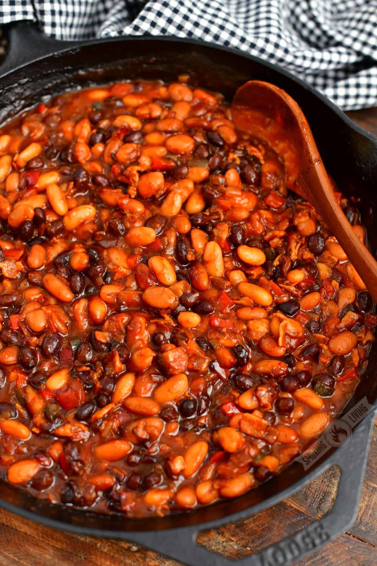 top view of the skilled with smoked baked beans and a spoon