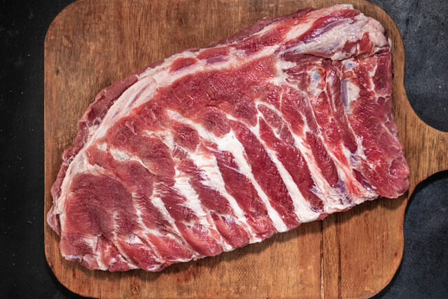 Raw fresh spareribs on wooden board