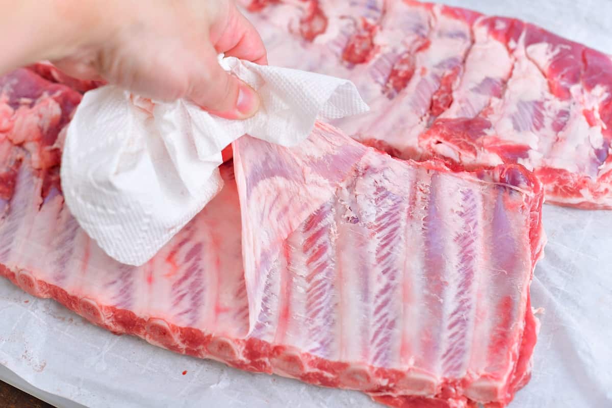 pulling off the membrane from the back of St. Louis ribs