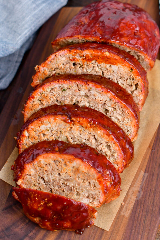 top view of sliced meatloaf on a wooden cutting board