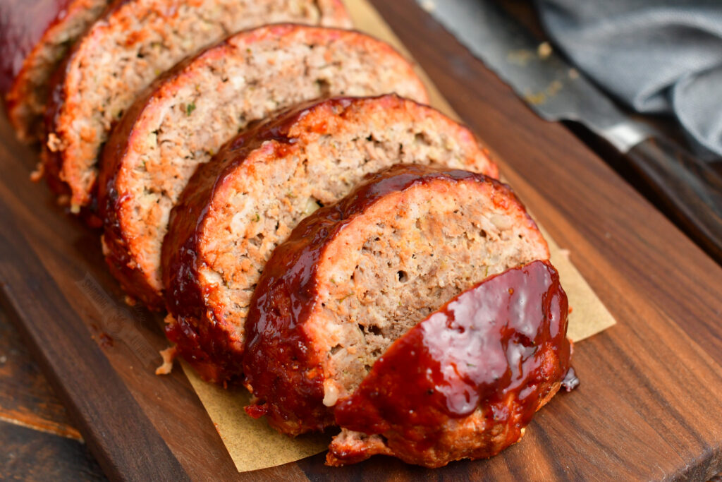 closer image of sliced meatloaf with BBQ sauce