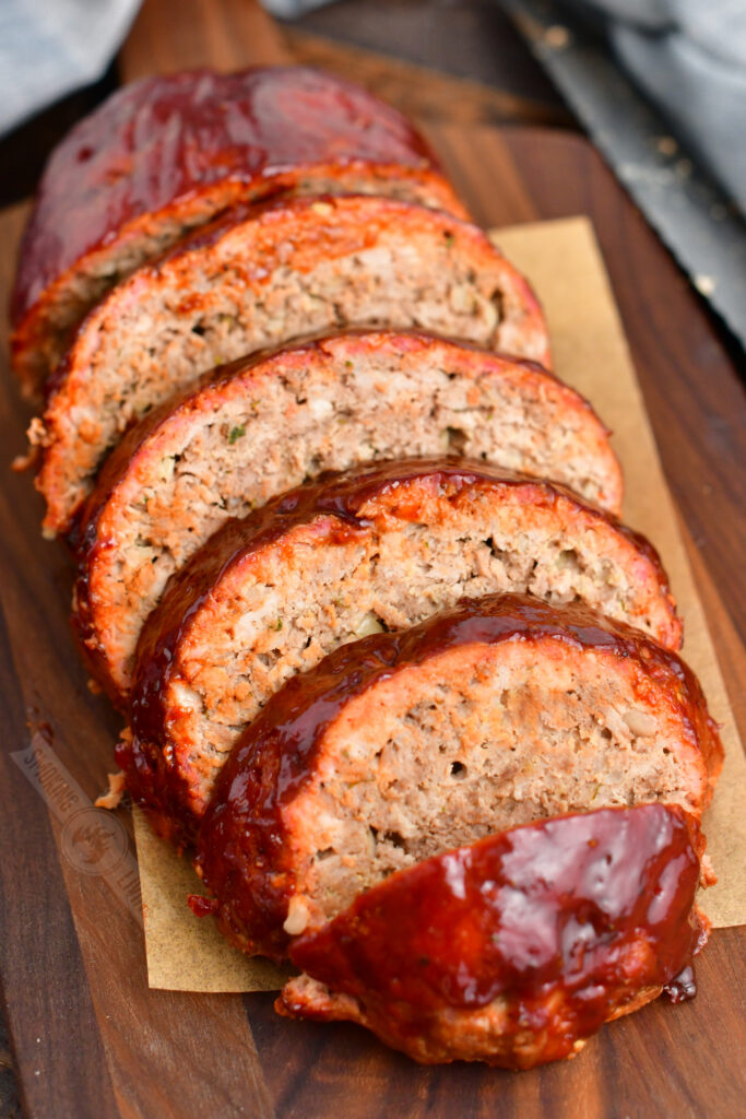 top left view of smoked meatloaf sliced on the board