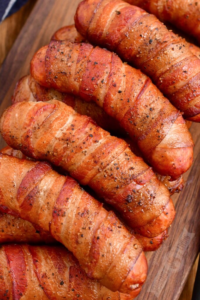 stacked smoked sausage on a wooden board