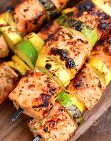 closeup of grilled salmon and vegetables on skewers