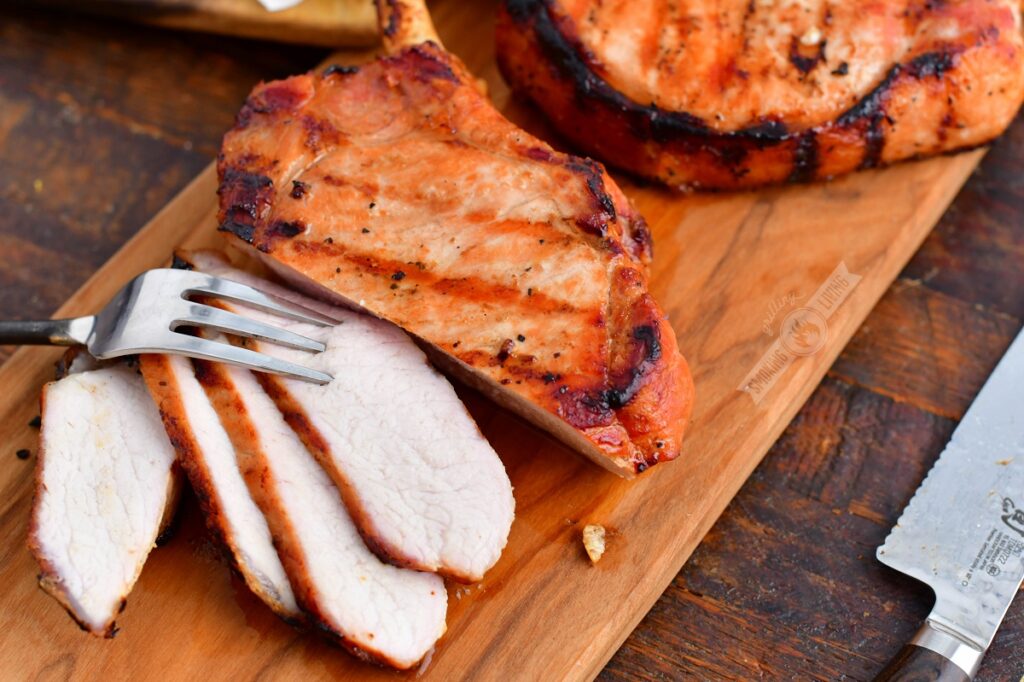 closeup of sliced pork chops with a fork