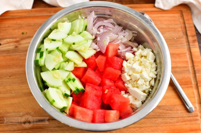 ingredients for the watermelon salad cut in a mixing bowl