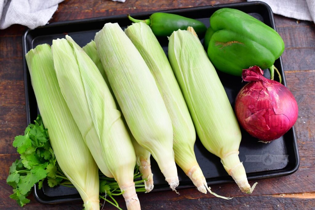 ingredients for grilled corn salad on a metal tray