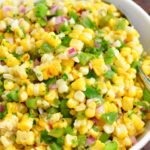 finished grilled corn salad in a white bowl