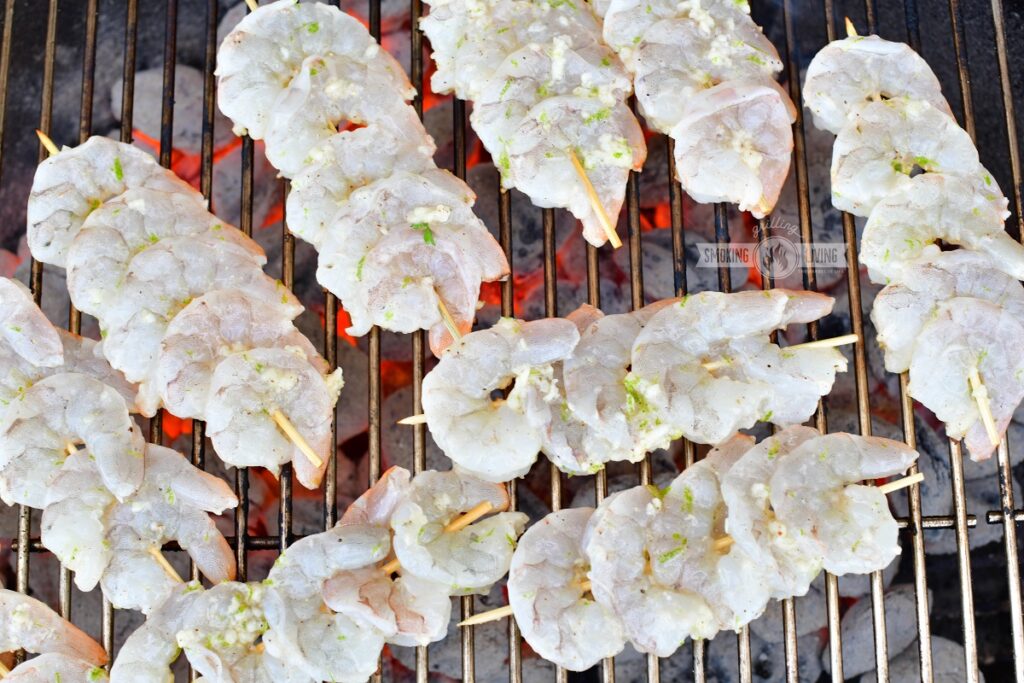uncooked shrimp skewers on the grill