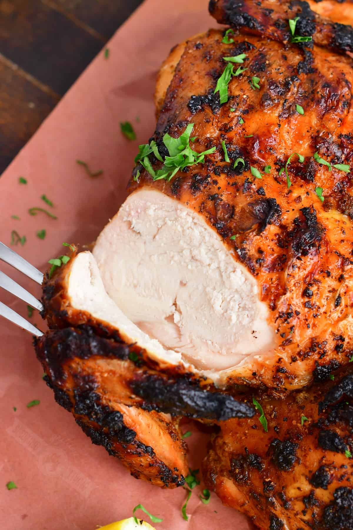closeup of sliced chicken breast of the grilled whole chicken