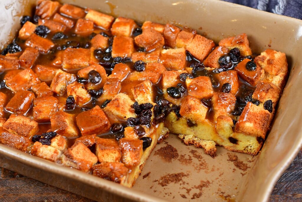 smoked bread pudding in a baking dish with slice taken out