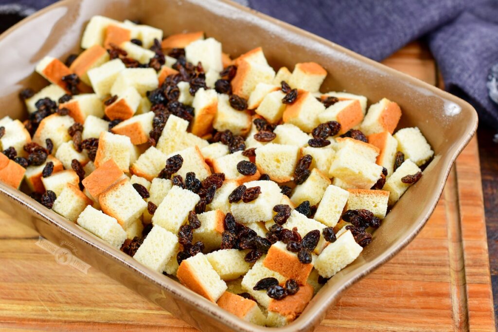 cubed bread and raisins in a baking dish
