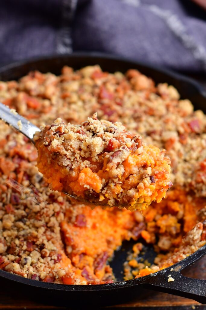 spoonful of sweet potato casserole with pecan crunch topping