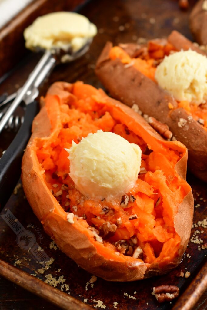 closeup of smoked sweet potato topped with maple butter and pecans