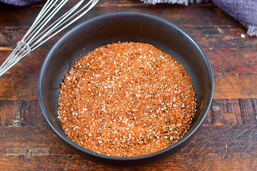 mixed spices for dry rub in a black bowl