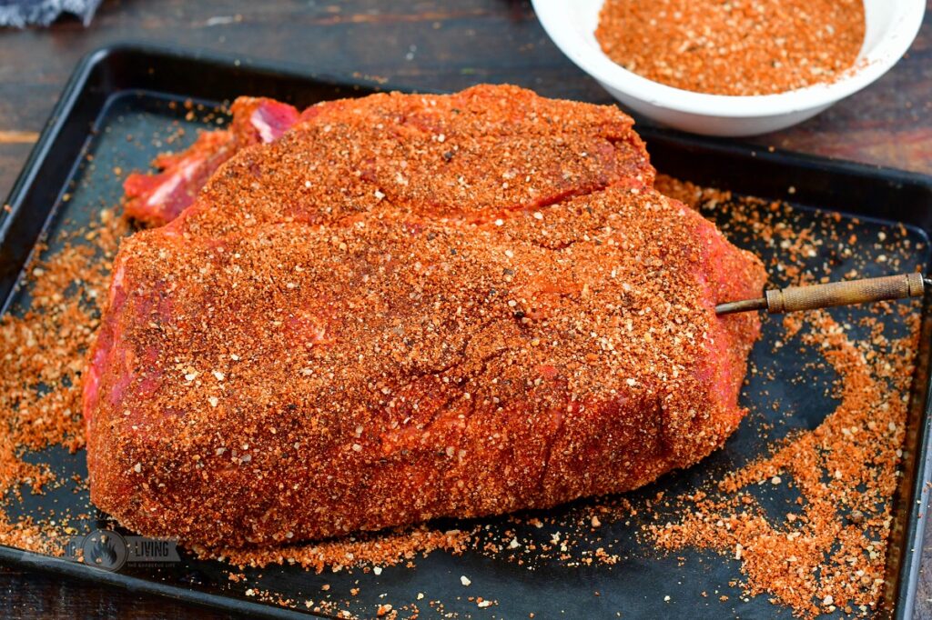 seasoned beef chuck on a baking sheet with thermometer