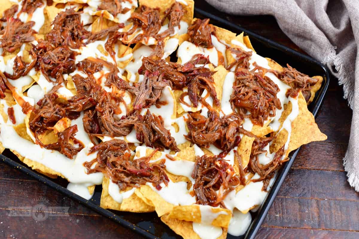 tortilla chips with queso and pulled beef