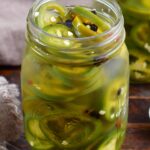 closeup of pickled jalapenos in a jar