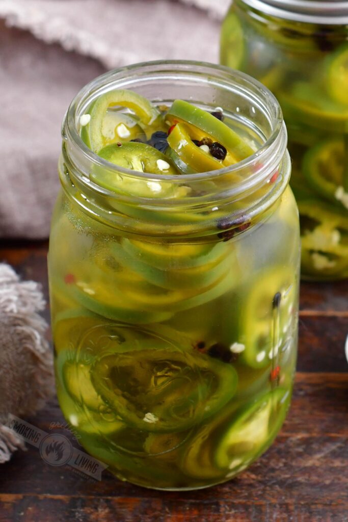 closeup of pickled jalapenos in a jar