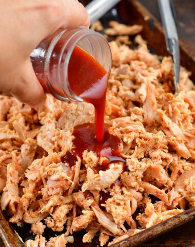adding BBQ sauce to pulled chicken