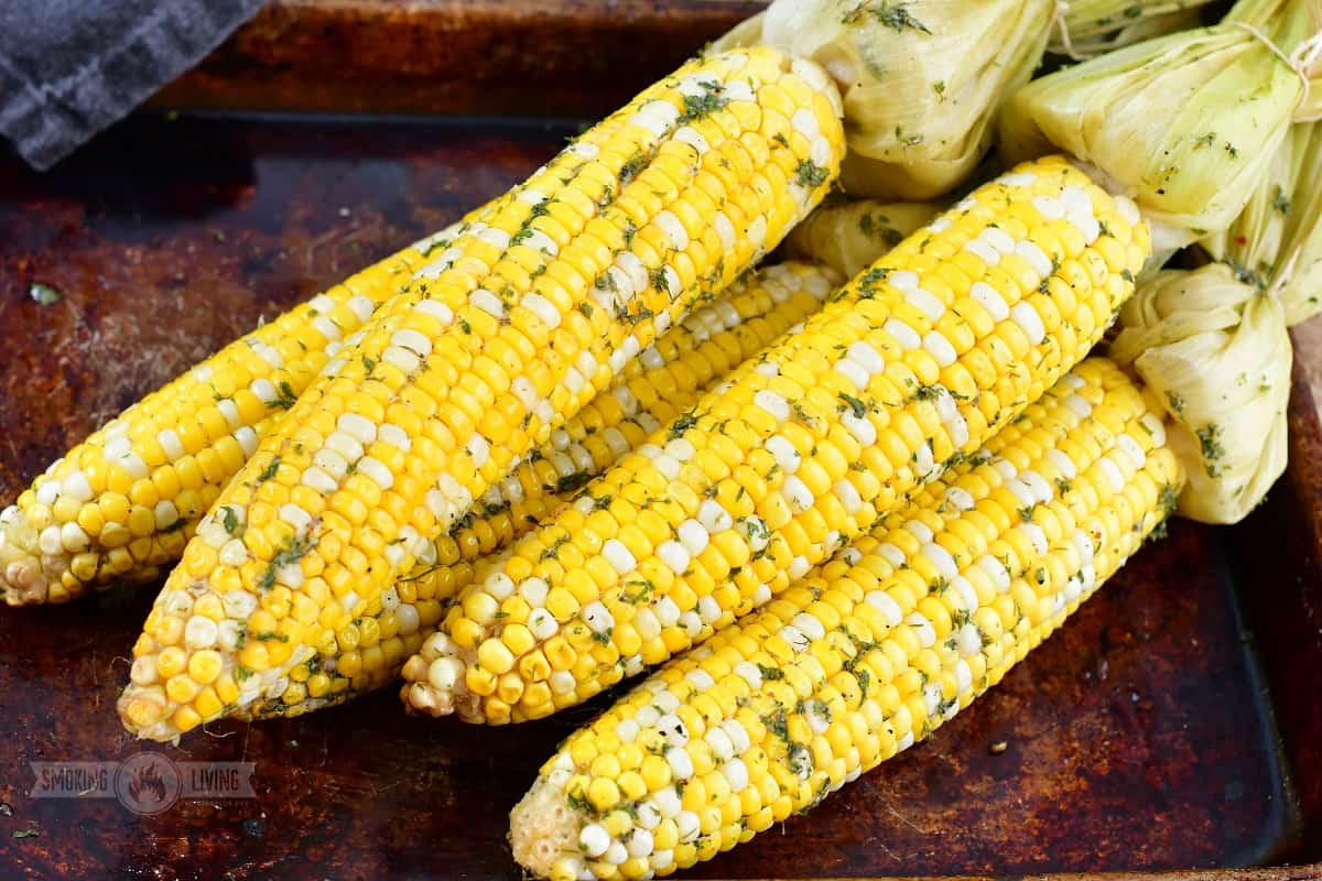 closeup of smoked corn on the cob on the pan