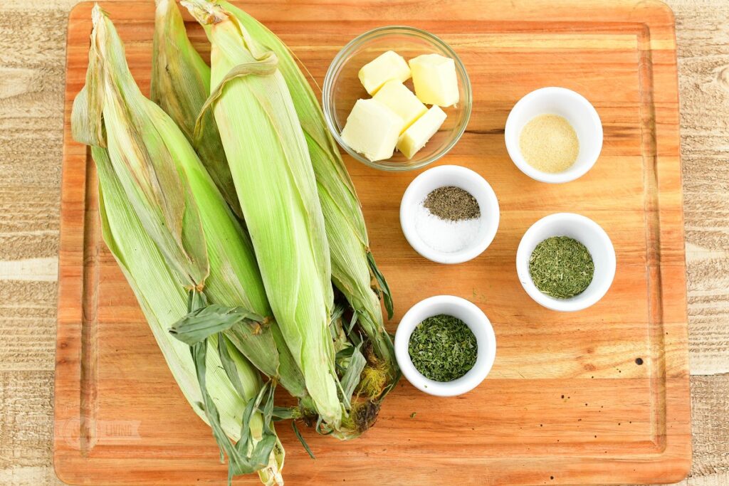 ingredients for smocking corn on the cob on the cutting board