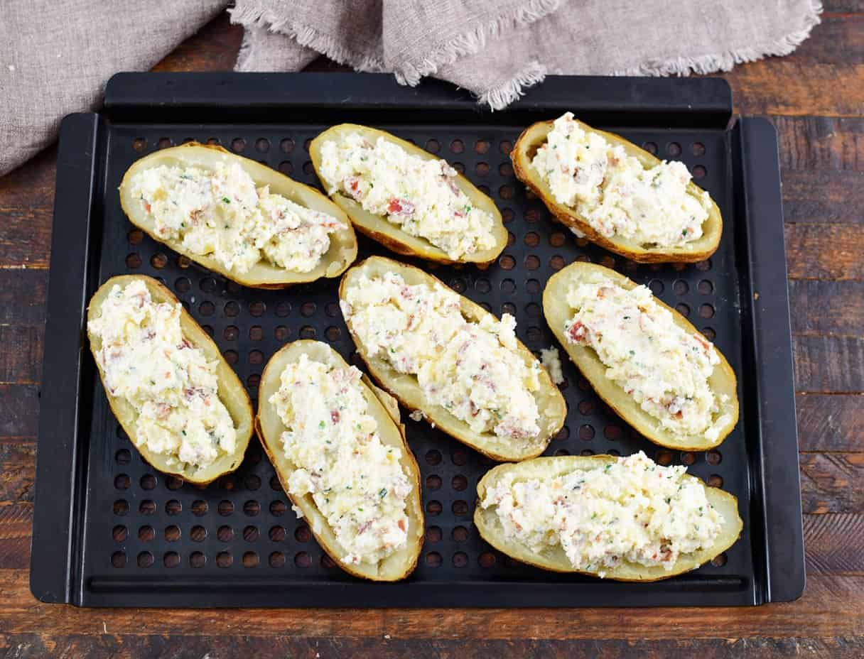 cooked potatoes with filling on a tray