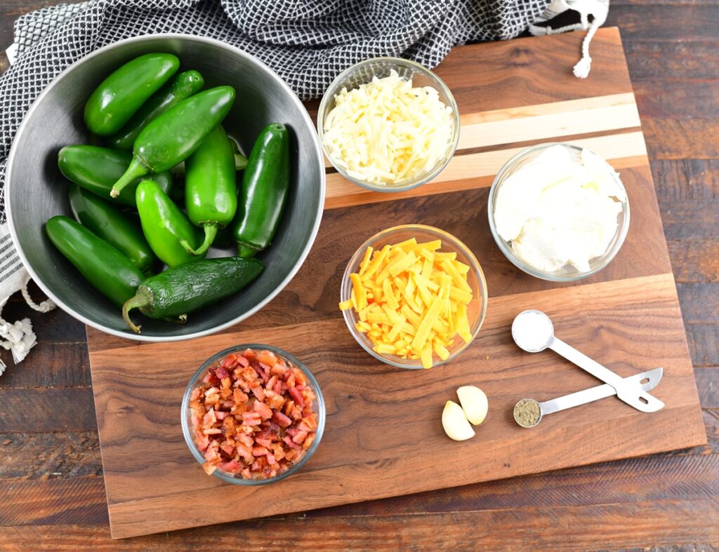 Jalapeno poppers ingredients on wood cutting board
