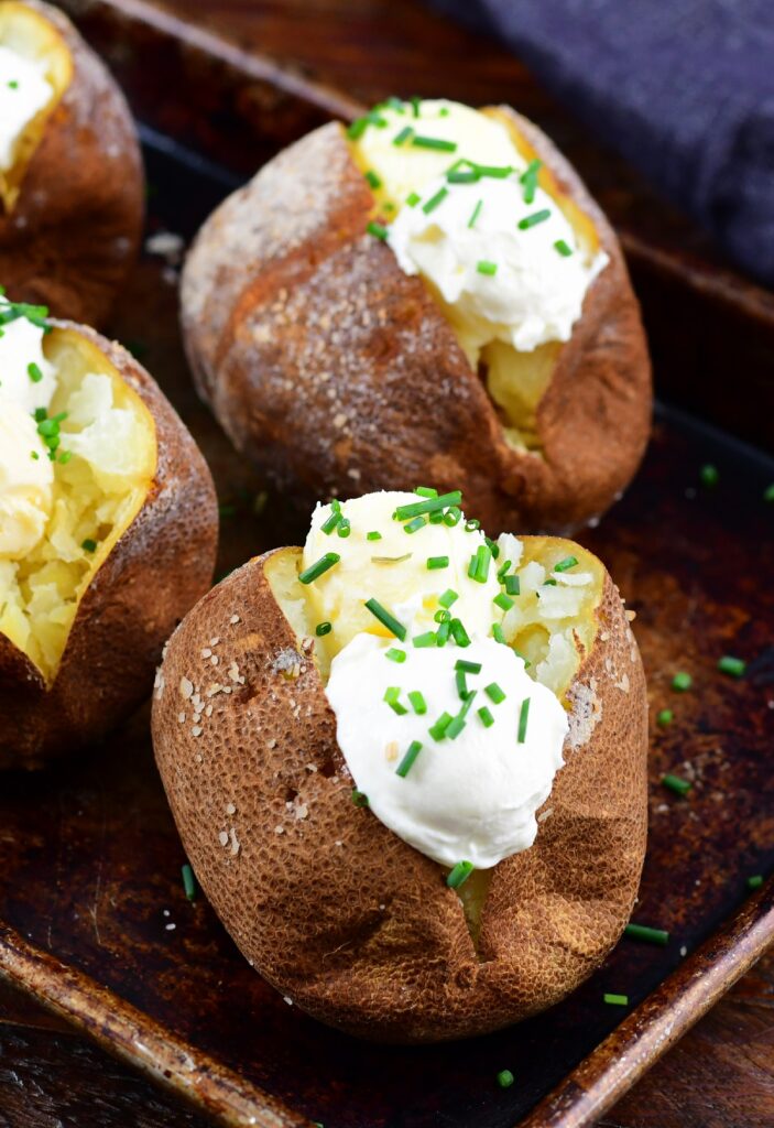 Butter and sour cream on smoked baked potatoes
