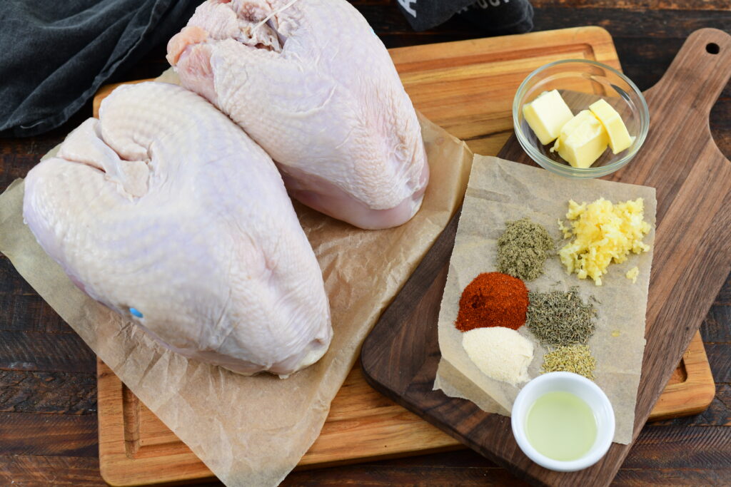 raw turkey and seasonings on 2 cutting boards