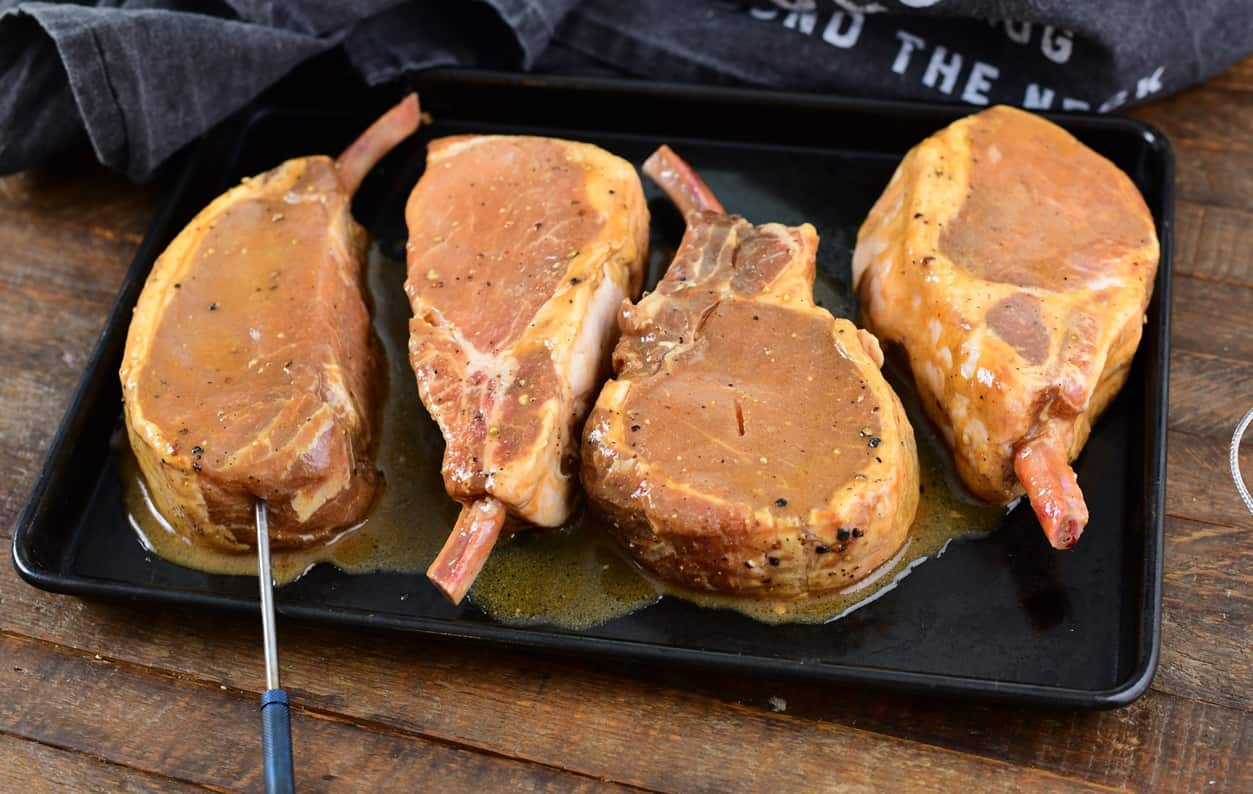 raw pork chops on a cooking tray