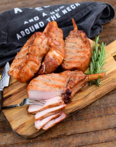 sliced smoked pork chops on a wooden cutting board