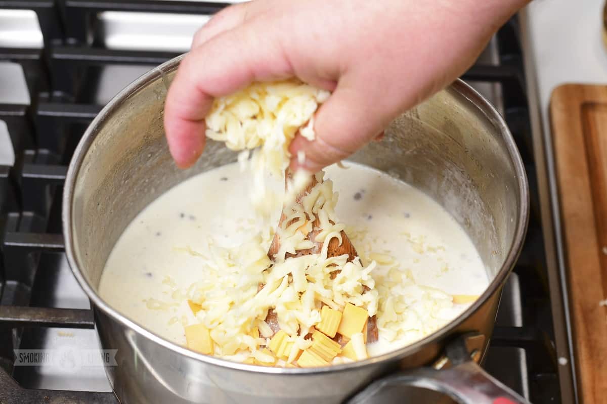cheese being added to cream and milk