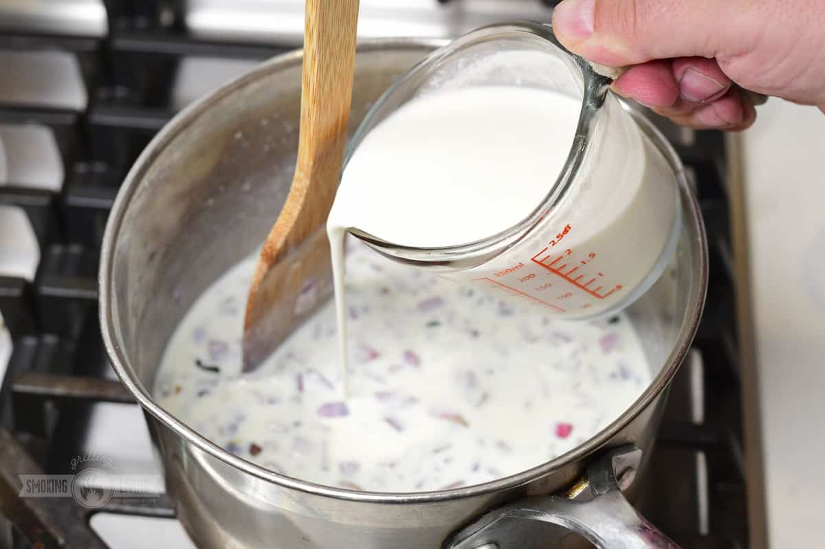 Milk poured into cooking dip
