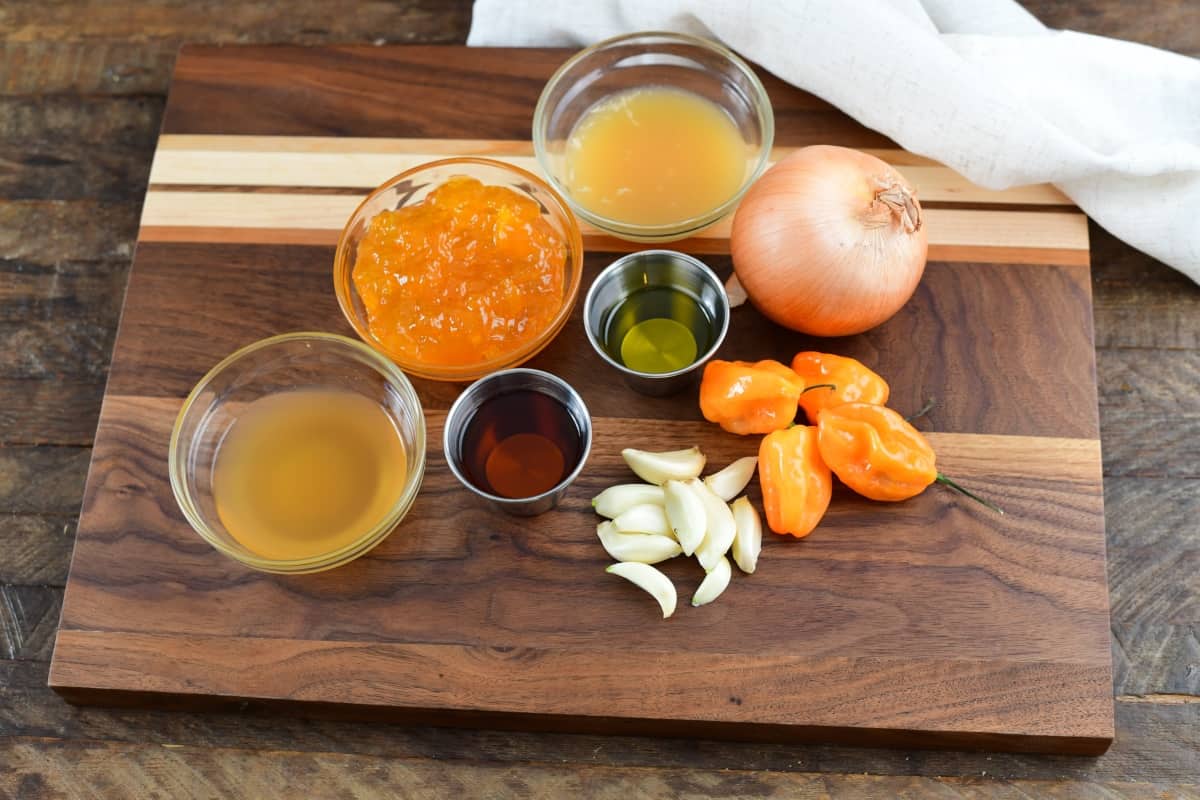 Ingredients on a wooden cutting board for wing sauce.
